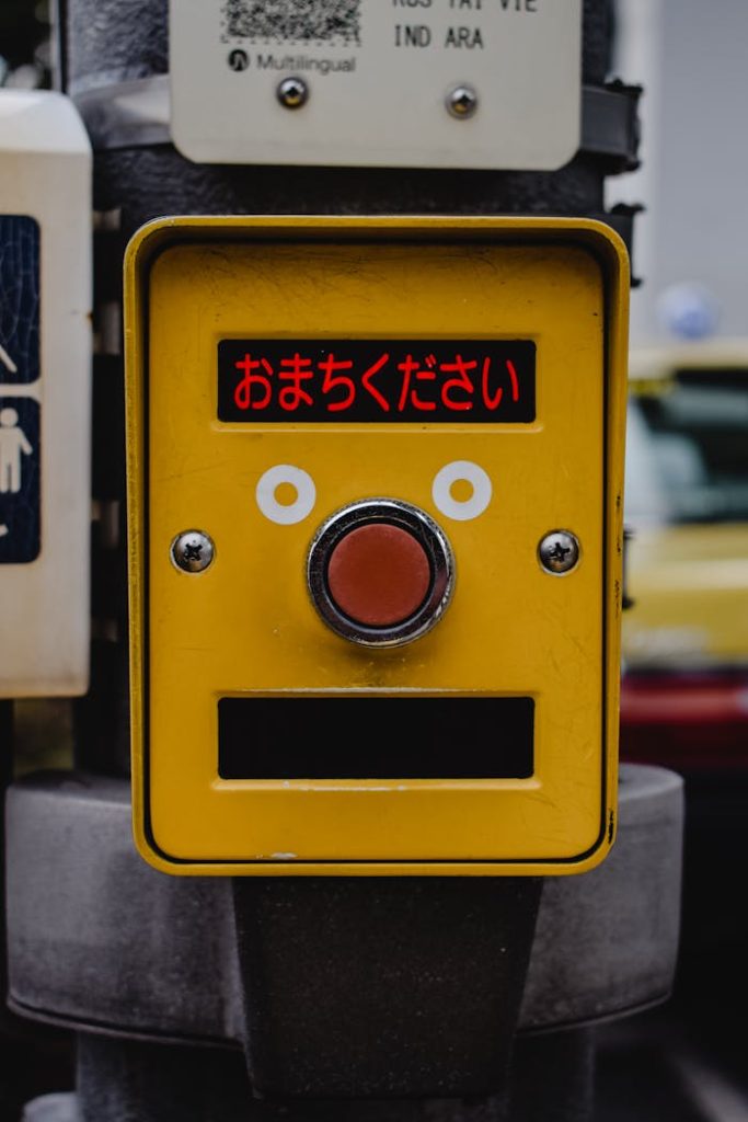 Demo Post 3 Yellow pedestrian signal button with Japanese text on a city street corner.