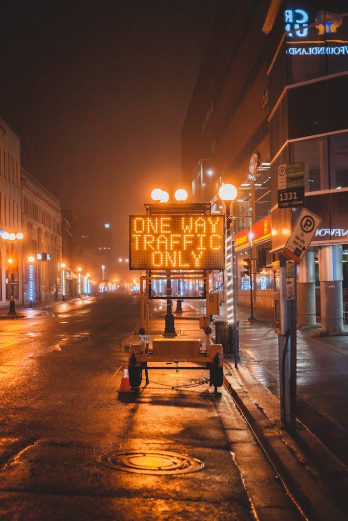 Demo Post 1 Mobile electronic sign with inscription One way traffic only placed on wet asphalt road on street in city in night time